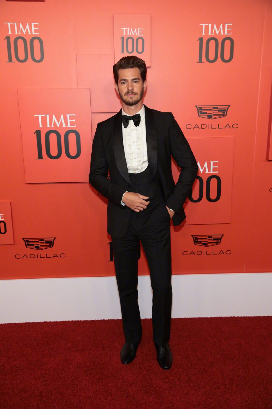 Andrew Garfield in a dark suit at a press event